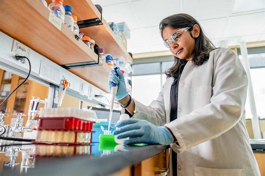 Tanvi Govil. A scientist in a lab conducting experiments.