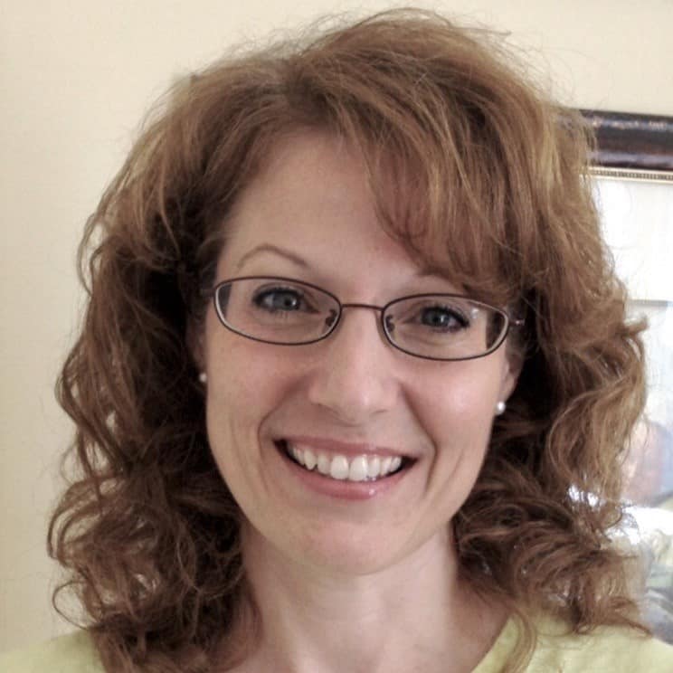 Laura Moley, the woman in glasses and a yellow shirt.